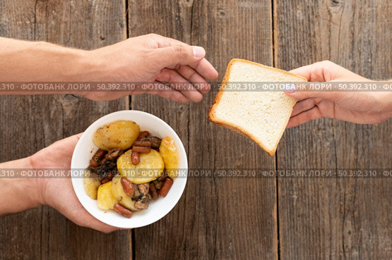 hand giving bowl food bread needy person. Стоковое фото, агентство Ingram Publishing / Фотобанк Лори