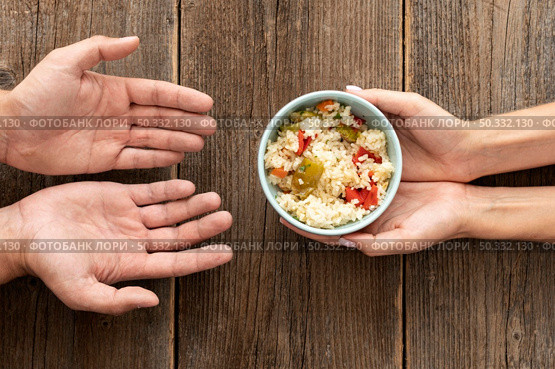 hand giving bowl food needy person. High resolution photo. hand giving bowl food needy person. High quality photo. Стоковое фото, агентство Ingram Publishing / Фотобанк Лори