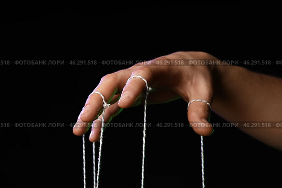 Hand of puppeteer on dark background. Стоковое фото, фотограф Pixel_shot / Фотобанк Лори