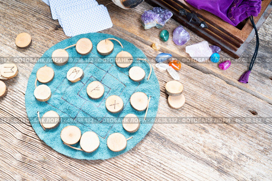 Handmade runes for fortunetelling over leather chart, magic rituals lifestyle. Handmade runes for fortunetelling. Стоковое фото, агентство Ingram Publishing / Фотобанк Лори