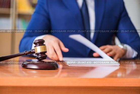 Handsome judge with gavel sitting in courtroom. Стоковое фото, фотограф Elnur / Фотобанк Лори
