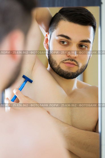Handsome man shaving his armpit. Стоковое фото, фотограф Яков Филимонов / Фотобанк Лори