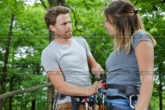 happy couple at climbing park showing climbing carbine for safety. Стоковое фото, агентство Ingram Publishing / Фотобанк Лори