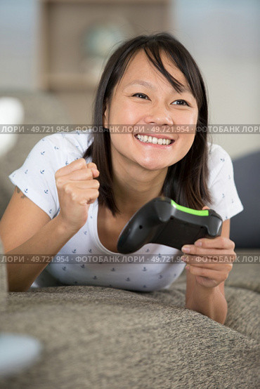 happy woman playing online won a video game competition. Стоковое фото, агентство Ingram Publishing / Фотобанк Лори