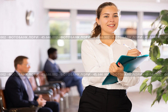Happy young woman standing with her back to waiting room. Стоковое фото, фотограф Яков Филимонов / Фотобанк Лори