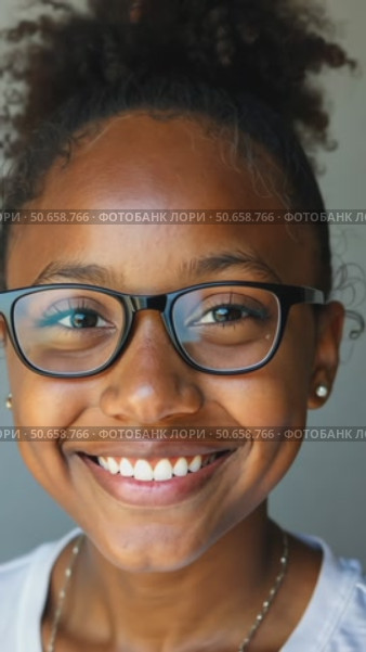 Headshot portrait of happy mixed race black african girl wearing glasses. Стоковое AI-видео, аниматор Sergey Grishin / Фотобанк Лори