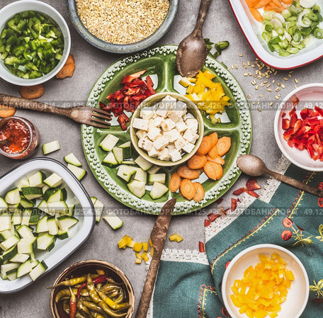 Healthy vegetarian salad preparation with Diced feta cheese, cut vegetables and  pearl barley , top view. Diet nutrition concept. Стоковое фото, агентство Ingram Publishing / Фотобанк Лори