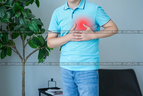 Heart attack, man with chest pain suffering at home, myocardial infarction. Стоковое фото, фотограф Станислав Тарко / Фотобанк Лори