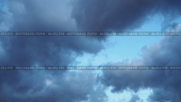 Heavy clouds fill the sky, signaling an impending storm. The atmospheric change creates a dramatic backdrop as daylight wanes, hinting at rain on the horizon. Стоковое видео, видеограф Юлия Петровская / Фотобанк Лори