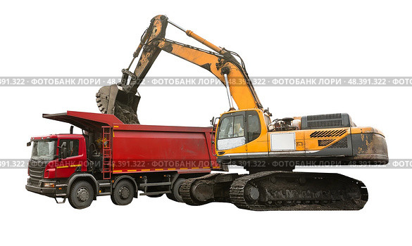 Heavy construction excavator loading soil into dump truck, isolated on white background, industrial machinery working on construction site, earthmoving equipment for excavation, transportation tasks. Стоковое фото, фотограф Сергей Тимофеев / Фотобанк Лори