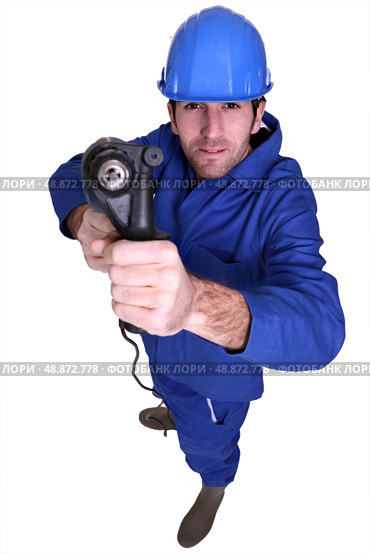 high angle shot blue collar using drill. Стоковое фото, агентство Ingram Publishing / Фотобанк Лори