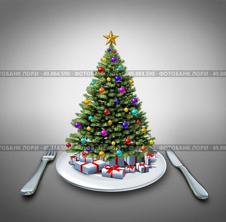 Holiday dinner and winter celebration food recipe as a decorated pine christmas tree on a table setting with a plate fork and knife as a symbol of eating during the holidays. Стоковое фото, агентство Ingram Publishing / Фотобанк Лори