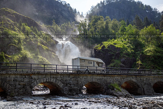 Holiday trip in motorhome, Caravan car Vacation. RV traveling on the road Latefossen Waterfall Odda Norway. Latefoss is a powerful, twin waterfall. Стоковое фото, фотограф Андрей Армягов / Фотобанк Лори