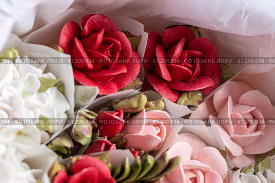 Home-made zephyr floristry arrangement featuring vibrant red, pink, and white floral designs, showcasing intricate details and textures in a beautifully crafted presentation. Стоковое фото, фотограф Ирина Ручушкина / Фотобанк Лори