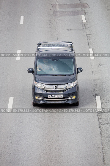 Honda Stepwgn Spada minivan driving along the street, front above view. Редакционное фото, фотограф Константин Григорьев / Фотобанк Лори