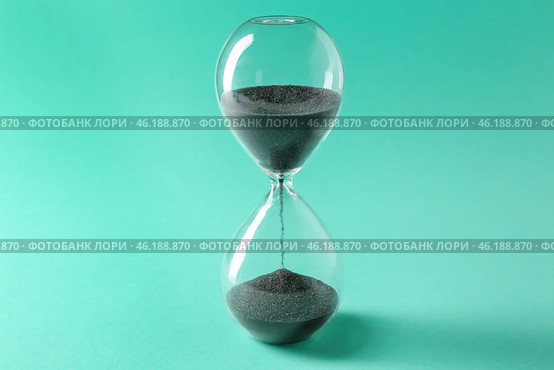 Hourglass on color background. Time management concept. Стоковое фото, фотограф Pixel_shot / Фотобанк Лори