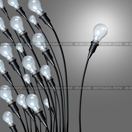 Independent idea business concept and new creative thinking and individual creativity symbol or going it alone breaking away from a group as a a bunch of lightbulbs leaning on one side and an individual light setting a new path. Стоковое фото, агентство Ingram Publishing / Фотобанк Лори