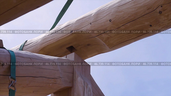Installation of wooden beams at construction the roof truss system of the house. Стоковое фото, фотограф David Kashakhi / Фотобанк Лори