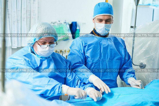 Interventional cardiology. Male surgeon doctor at operation. Стоковое фото, фотограф Дмитрий Калиновский / Фотобанк Лори