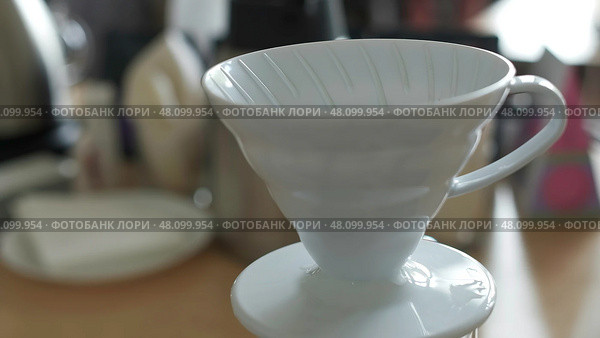 Introducing the Elegant White Coffee Dripper that is perfect for Brewing Fresh Coffee at home. Стоковое фото, фотограф David Kashakhi / Фотобанк Лори