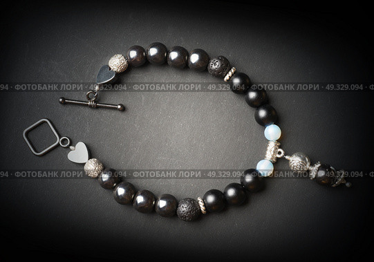 jewel handmade bracelet with semipreciouse stones at black background. Стоковое фото, агентство Ingram Publishing / Фотобанк Лори