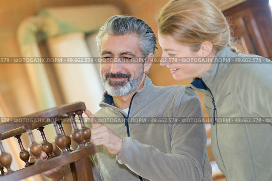 joiner checking the finish of a furniture. Стоковое фото, агентство Ingram Publishing / Фотобанк Лори