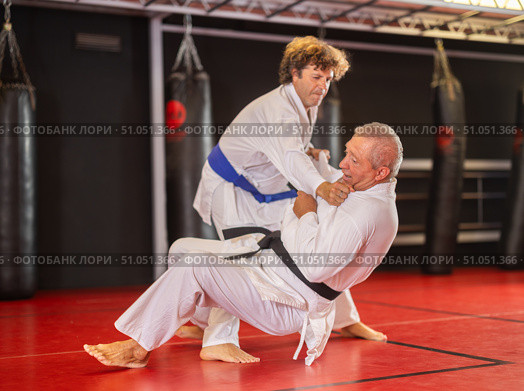 Karate with male athletes practicing, training and sparring in fight class. Стоковое фото, фотограф Яков Филимонов / Фотобанк Лори
