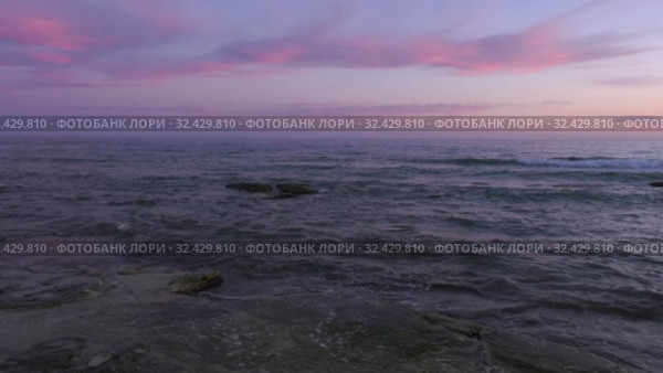 Каспийское море на закате. Волны набегают на скалистый берег. Caspian Sea at sunset. Waves run onto a rocky shore. Стоковое видео, видеограф Евгений Романов / Фотобанк Лори