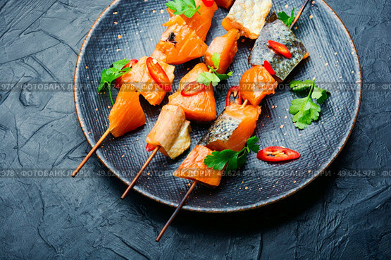 Kebabs from dried and salmon on wooden skewers.Delicious smoked fish. Dried fish salmon. Стоковое фото, агентство Ingram Publishing / Фотобанк Лори