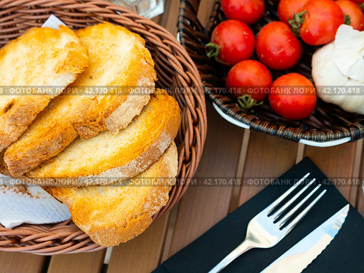 Kitchen table with cooking tools and fresh vegetables. Pan Con tomate, bread with tomato and garlic. Catalonian cuisine. Spain. Стоковое фото, фотограф Яков Филимонов / Фотобанк Лори