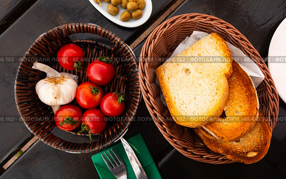Kitchen table with cooking tools and fresh vegetables. Pan Con tomate, bread with tomato and garlic. Catalonian cuisine. Spain. Стоковое фото, фотограф Яков Филимонов / Фотобанк Лори