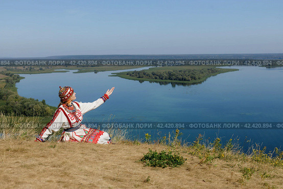 Kozlovsky district,Chuvashia/Russian Federation - 08.17.2022 - a woman in Chuvash national dress at the tourist site "Bird Flight" Редакционное фото, фотограф Андриян Григорьевич Чаркин / Фотобанк Лори
