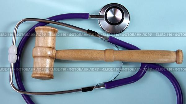 Крупный план судейского молотка и стетоскопа. Концепция пересечения права и медицины. Стоковое фото, фотограф Жанна Гапанович / Фотобанк Лори