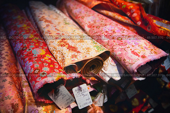 Kyoto, Japan - November 09, 2018: Close-up of kimono material for sale in a market in Kyoto city, Japan. Kimono textiles can to be classified into two categories: Gofuku, which indicates silk textiles in general, for luxuries and cotton/hemp Futomono for everyday wear.. Close-up of kimono material for sale in a market in Kyoto city, Japan. Редакционное фото, агентство Ingram Publishing / Фотобанк Лори