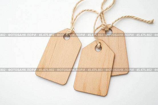 Label tag mockup. Wooden tag set hanging isolated on white background. Blank Gift or Price Tab with string cord knot. Price Label With Rope. Empty space for text. Price labeling or gift tagging. Sale. Стоковое AI-изображение, AI-художник Марина Демидюк / Фотобанк Лори