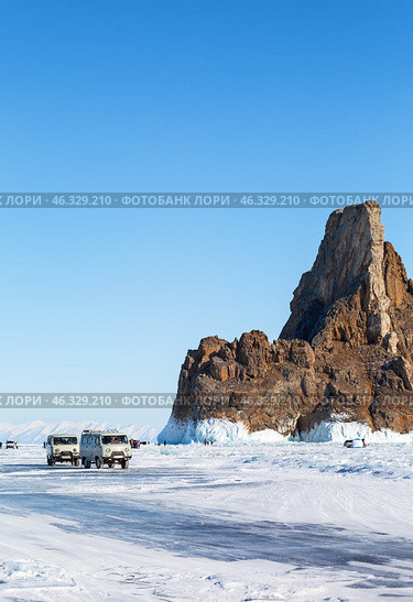 LAKE BAIKAL, OLKHON ISLAND, IRKUTSK REGION, RUSSIA -  February 22, 2025: Tourists love to come across ice of frozen Lake Baikal to famous Cape Khoboy - natural landmark of Olkhon Island. Редакционное фото, фотограф Виктория Катьянова / Фотобанк Лори