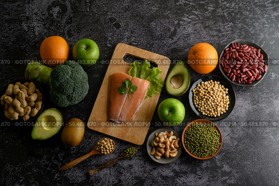 legumes, fruit, and Salmon fish pieces on a wooden chopping board. Стоковое фото, агентство Ingram Publishing / Фотобанк Лори