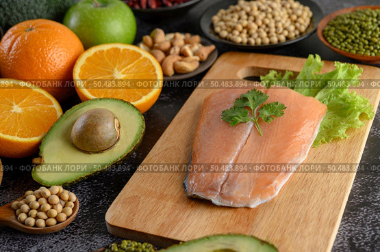 legumes, fruit, and Salmon fish pieces on a wooden chopping board. Стоковое фото, агентство Ingram Publishing / Фотобанк Лори