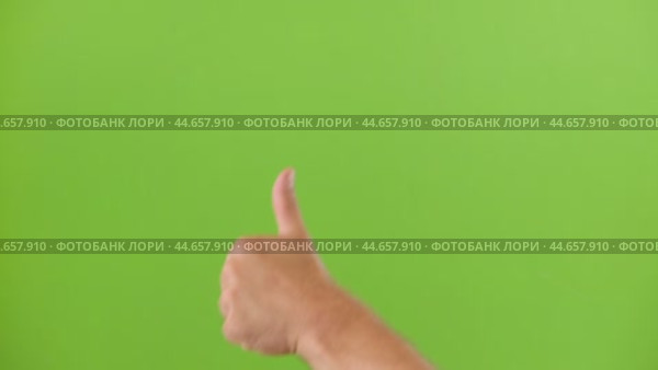 Like Gesture Hand Sign Emoji. Male Hand Showing Thumb Up Isolated Chroma Key Green Screen Background. Body Language. Close Up. Concept of Victory and Award. Support, Success, Vote Yes, Winning Goal. Стоковое видео, видеограф Марина Демидюк / Фотобанк Лори