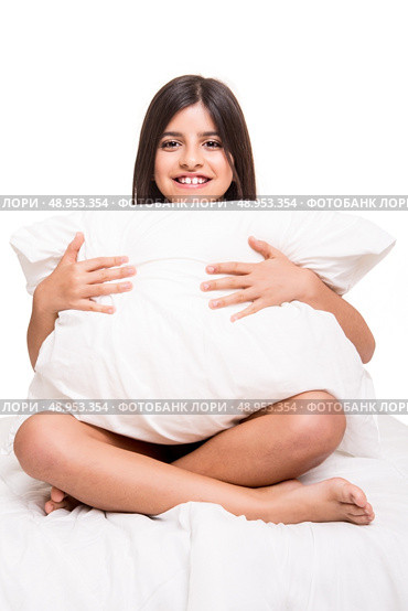 Little cute girl grabbing pillow over white. Стоковое фото, агентство Ingram Publishing / Фотобанк Лори