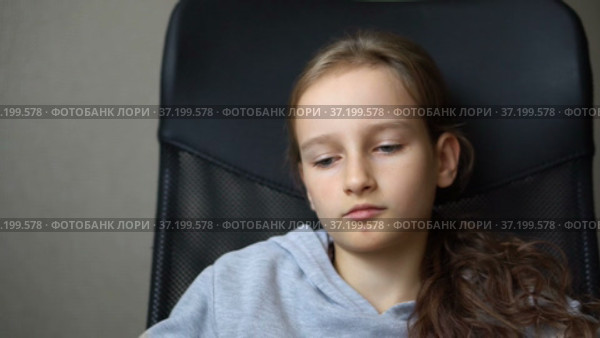 Little sad girl is sitting on black office chair, punishment, serious face. Стоковое видео, видеограф Ольга Балынская / Фотобанк Лори
