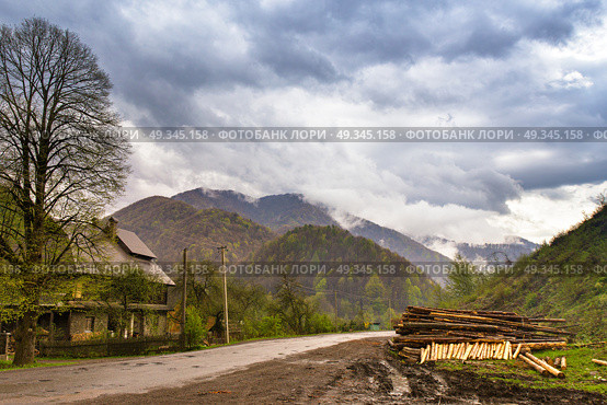 Logging in mountains. Spring stormy clouds. Rain in foggy green mountains. Стоковое фото, агентство Ingram Publishing / Фотобанк Лори