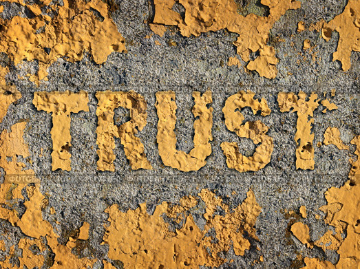 Losing trust and deteriorating integrity as a business concept represented by old fading yellow cracked paint on a rough cement wall showing the business metaphor of lost morality and illegal financial bank and stocks transactions. Стоковое фото, агентство Ingram Publishing / Фотобанк Лори