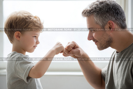 Loving father bumping fists with young son, expressing close familial connection through playful, affectionate gesture of bonding and shared joy. Стоковое AI-изображение, AI-художник Юрий Поздников / Фотобанк Лори