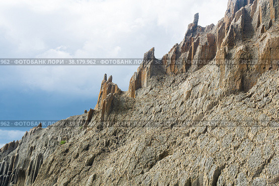 Majestic rocks from volcanic columnar basalt against the sky, natural landscape of Kunashir island. Стоковое фото, фотограф Евгений Харитонов / Фотобанк Лори
