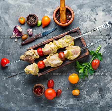 Making kebabs from meat-raw meat on skewers.Raw meat is cooked for shish kebab. Marinated BBQ meat. Стоковое фото, агентство Ingram Publishing / Фотобанк Лори