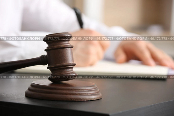 Male lawyer signing documents and judge gavel at table in office, closeup. Стоковое фото, фотограф Pixel_shot / Фотобанк Лори
