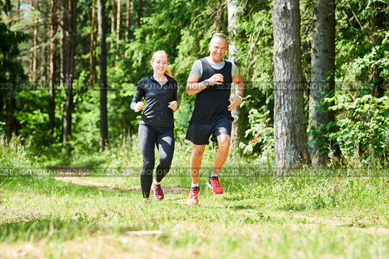 man and woman jogging and running outdoors in forest. Стоковое фото, фотограф Дмитрий Калиновский / Фотобанк Лори