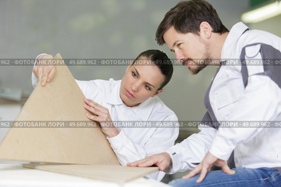 man and woman workers in the carpentry workshop. Стоковое фото, агентство Ingram Publishing / Фотобанк Лори