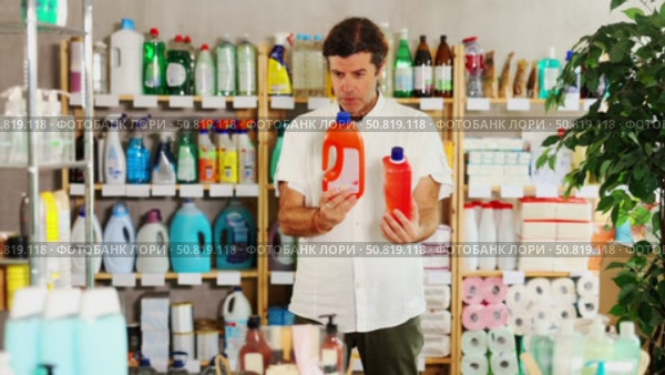 Man choose product and doubts, faultfinding buyer pick sewer cleaner liquid for allergy sufferers. Стоковое видео, видеограф Яков Филимонов / Фотобанк Лори